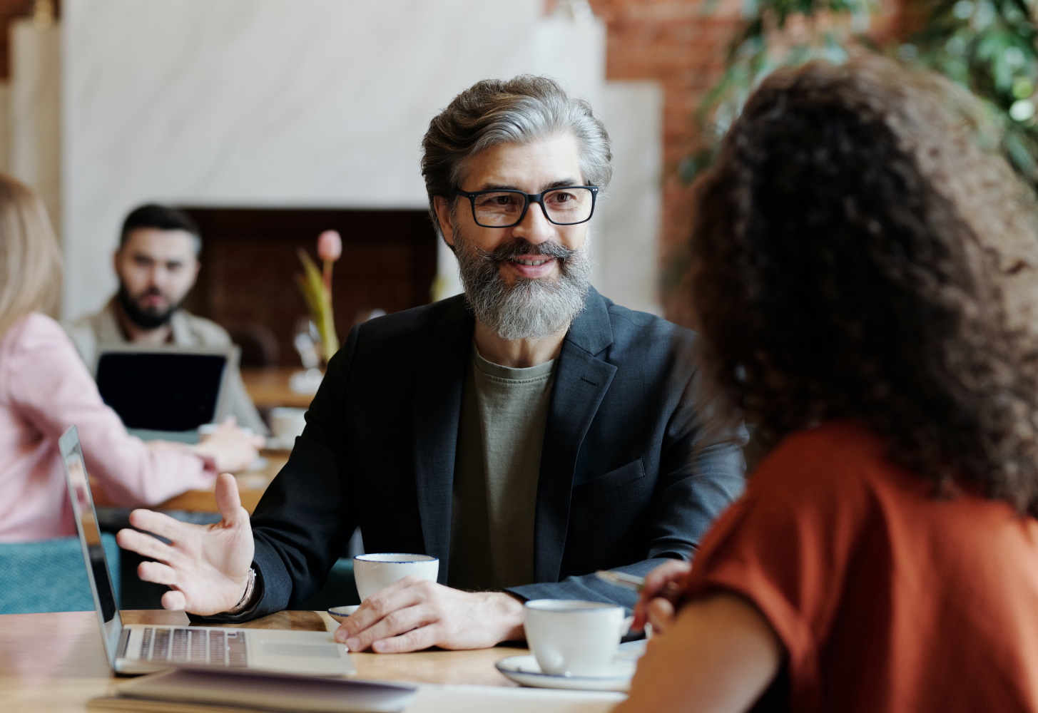 Mature man engaged in conversation with a woman 