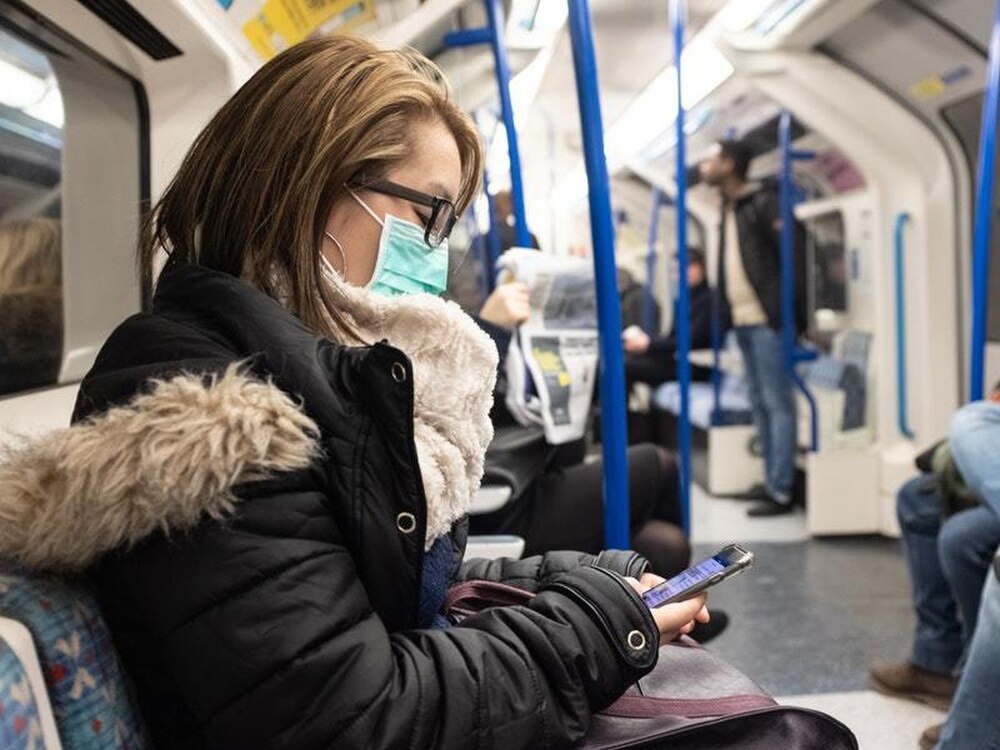 A woman on the London Underground wearing a facemask