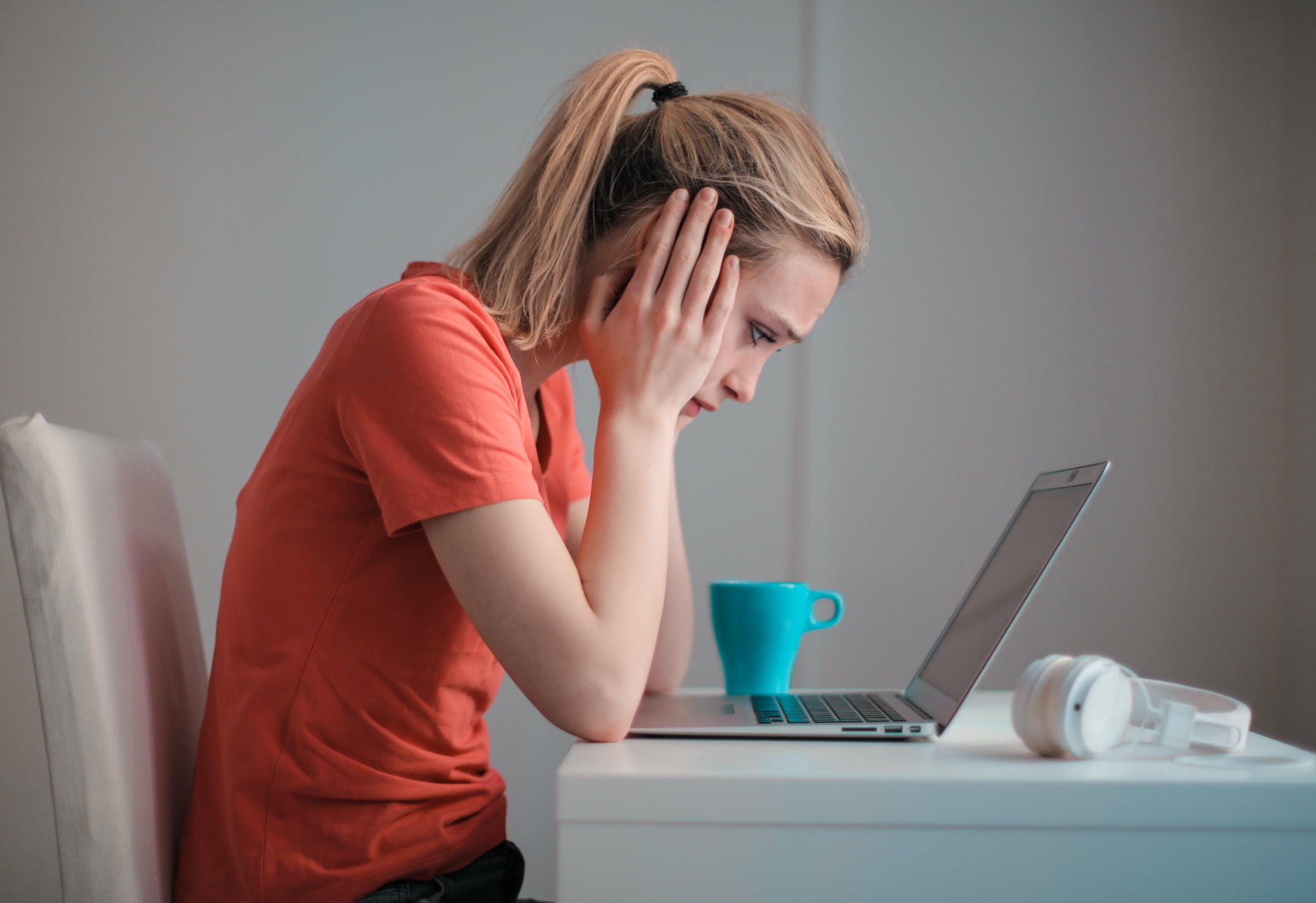 Female computer user staring worriedly at her laptop computer