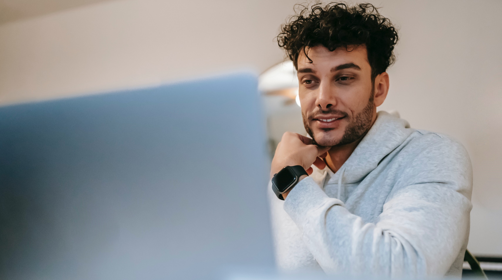 Happy guy using his laptop computer