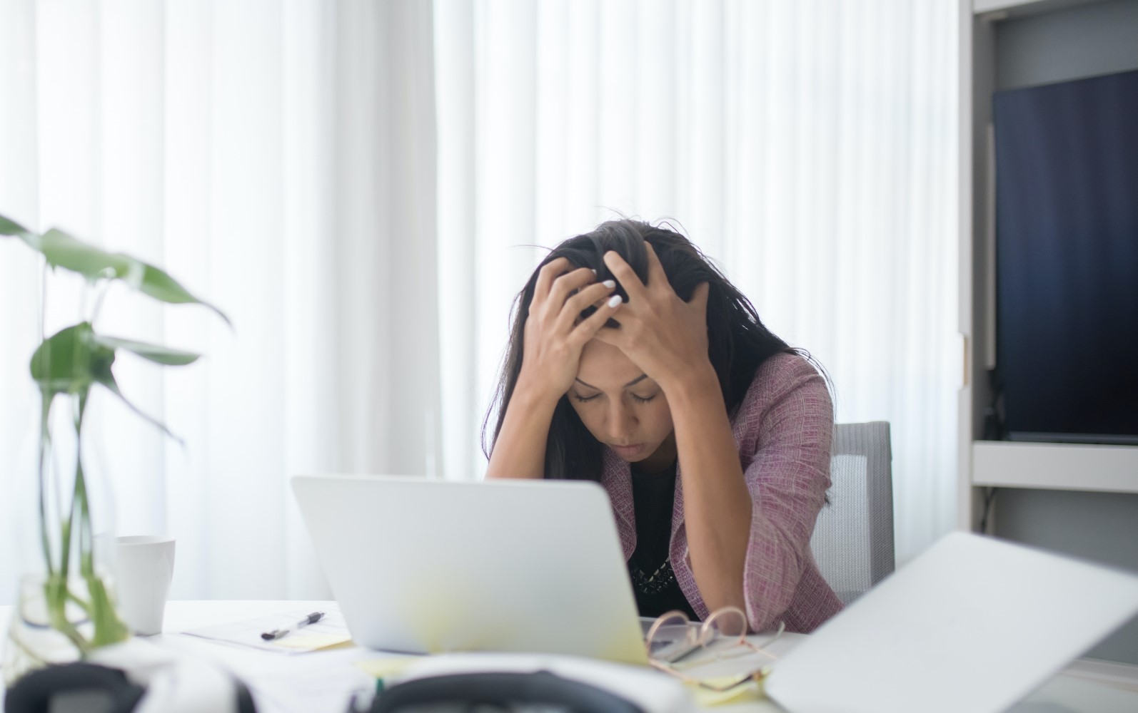 An anxious woman looking at her computer