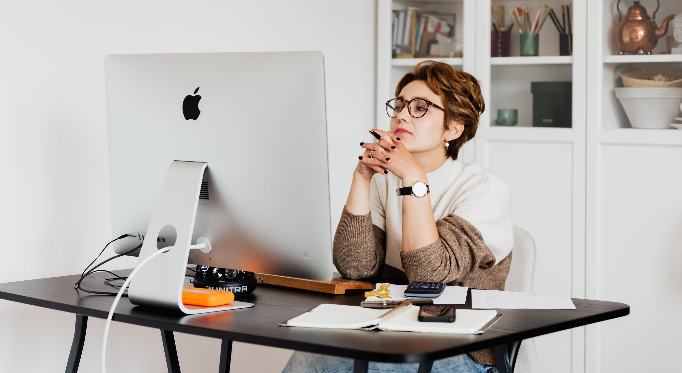 woman sat working at a Mac computer